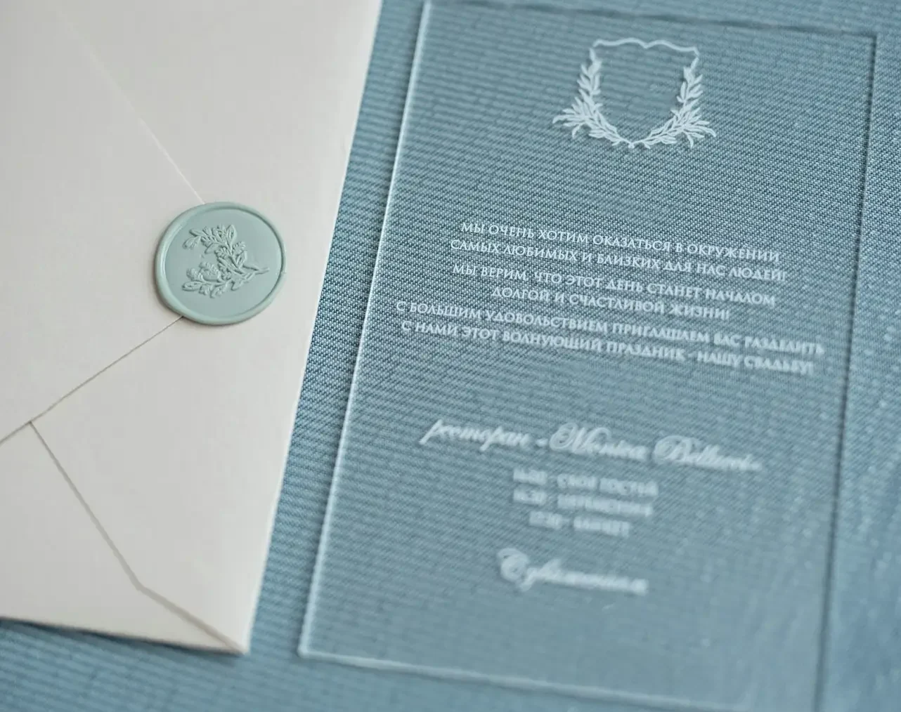 wedding invitation in a gray envelope on a table